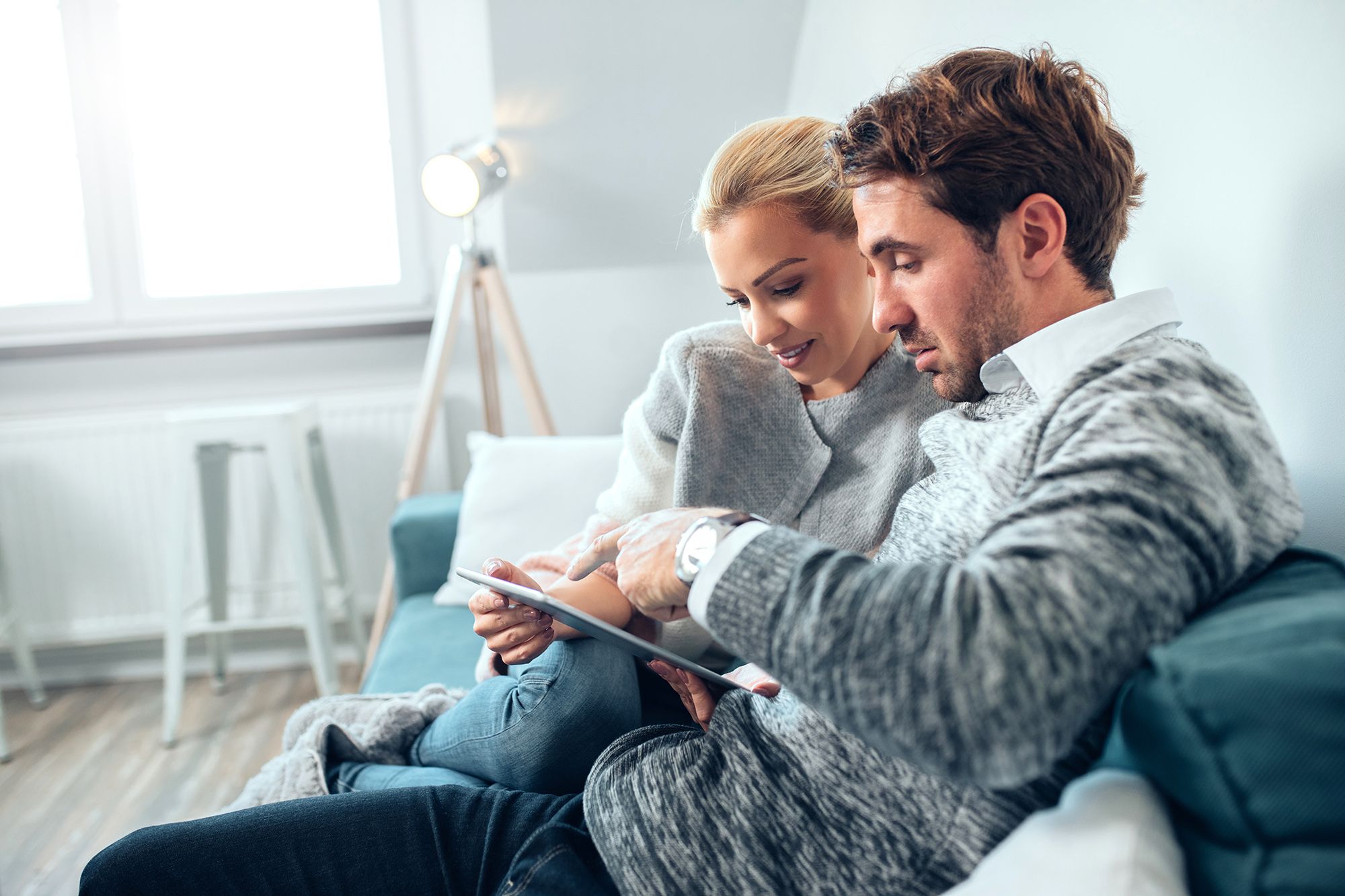 Couple,Having,Fun,Using,Digital,Tablet,At,Home.